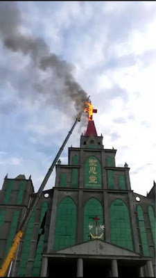 largest cross of the Holy Grace Church in Tanghe caught fire while being removed