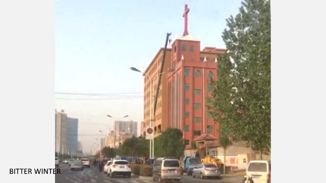 crane removing a cross