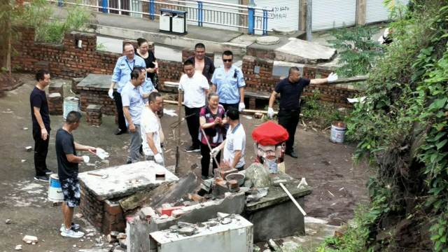 A senior steps forward to stop government workers from demolishing the temple.