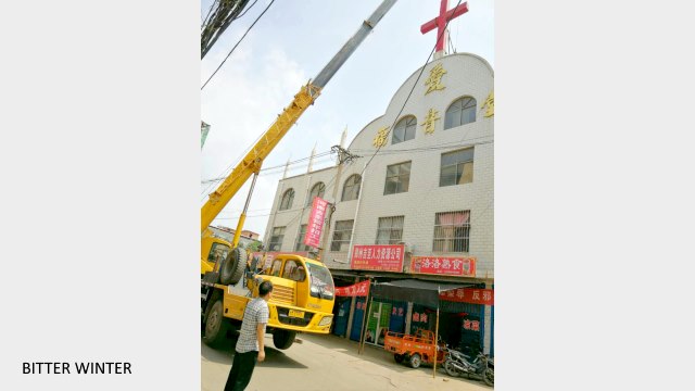 The cross is removed from the church in Yilihe village.