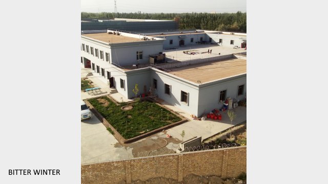 Police dormitory building at the “transformation through education camp” in Shule county’s Chengnan district. The dormitory building is surrounded by walls fitted with barbed wire.