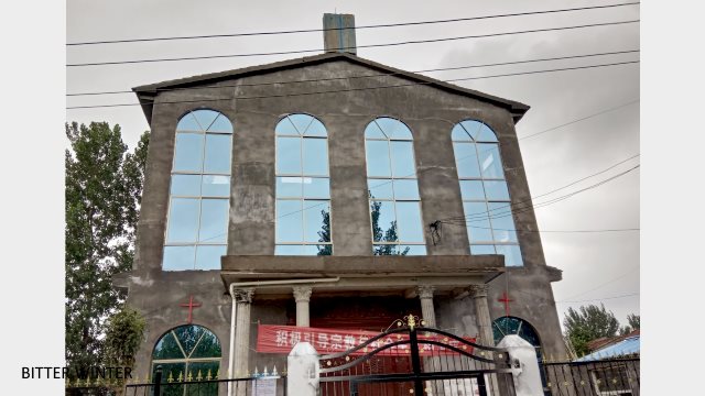 The cross on Xumazhuang Church in Liudian township, Xiayi county, Henan province is packed into a bucket using sheets of galvanized iron.