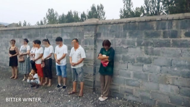 Believers look on as the cross is dismantled. With tears in their eyes, angry but afraid to speak, all they can do is pray.