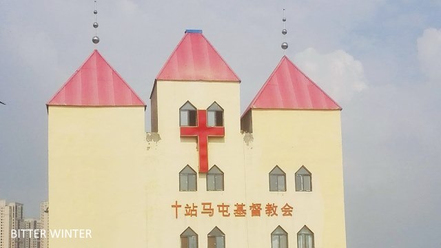 After being removed from the top of the church, the cross was moved onto the church’s exterior wall.