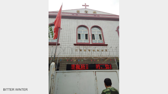 The front door of the church is locked and fenced off with iron wire.