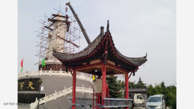 A crane is tearing down the statue 2