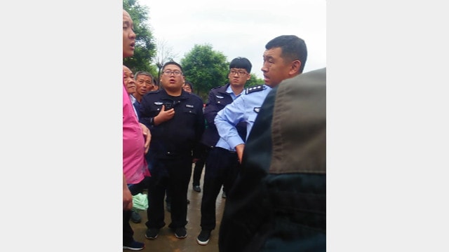 Police officers threaten the believers.