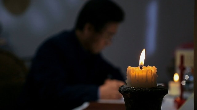 Priest Reading the Bible