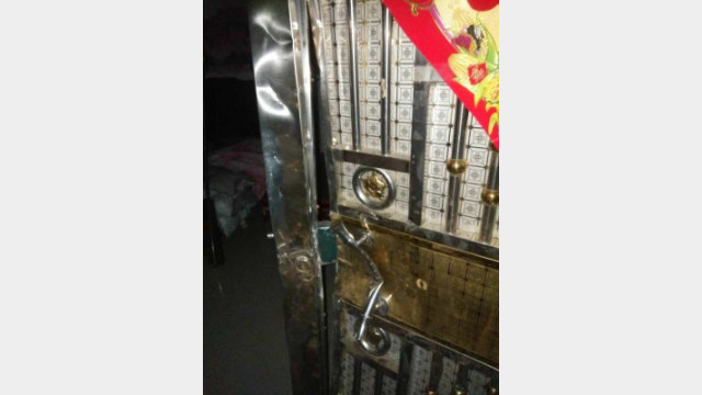 Police breaking down a door to seize people.