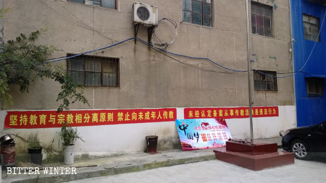 Political slogans are posted on the church’s wall