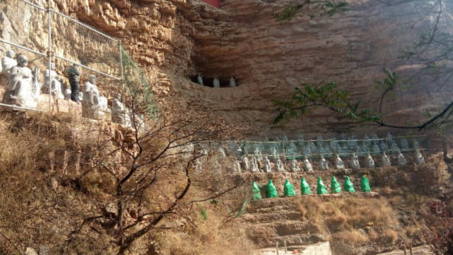 Some statues were covered with a green cloth.