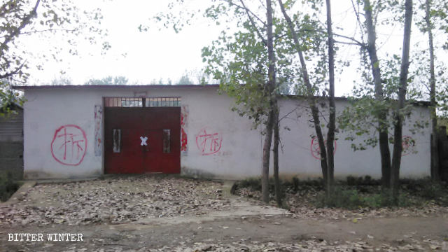 Word for “demolish” has been written on the perimeter wall