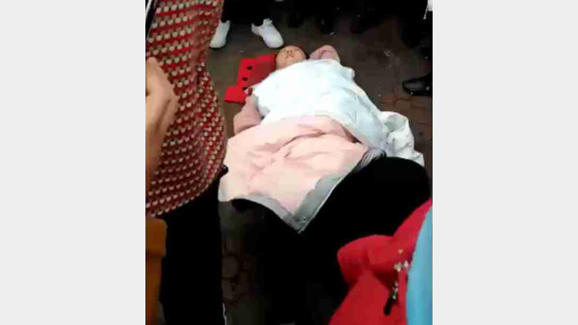 A woman is knocked to the ground.
