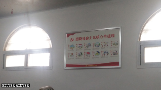 A billboard with propagandist slogans abuts the wall of a State-sanctioned Three Self church in Henan.