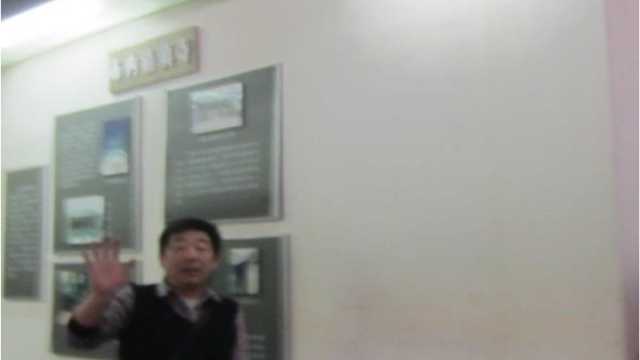 A security guard tries to prevent a picture