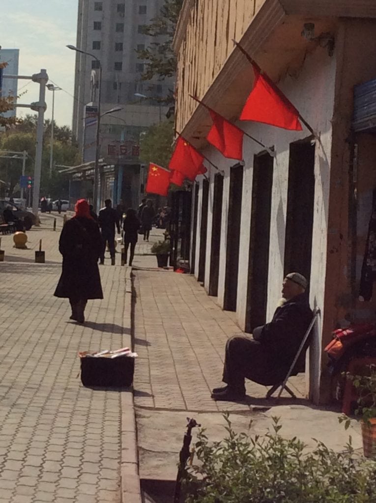 Basking in the shade of the Chinese red flag in Urumqi.
