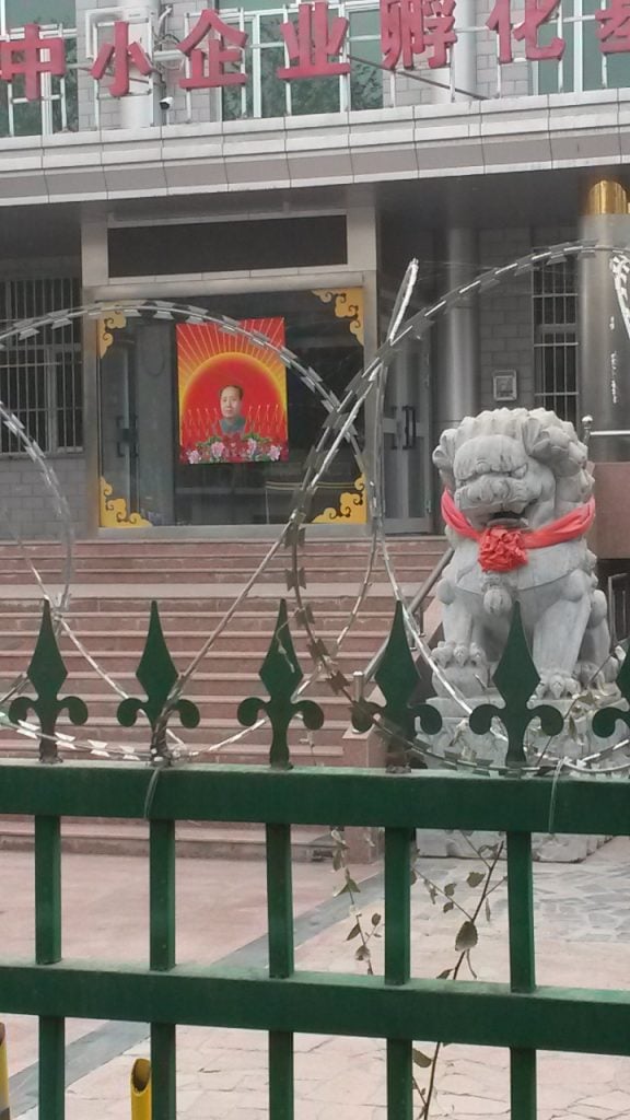 Chairman Mao's portrait outside the Small and Medium-sized Enterprise Incubator in the city of Turpan, in the east of Xinjiang. Mao Tse Tung's popularity is on the ascendant in Xinjiang