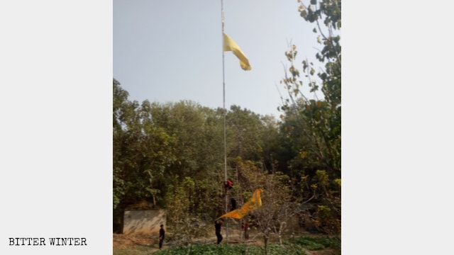 Government employees take down the temple’s banners.