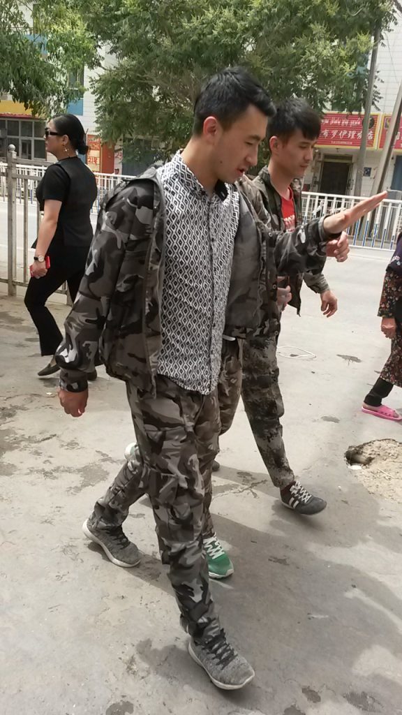 Hotan high school youth are drafted into the internal war on terror, sporting their new military-style summer school uniforms in 2018.