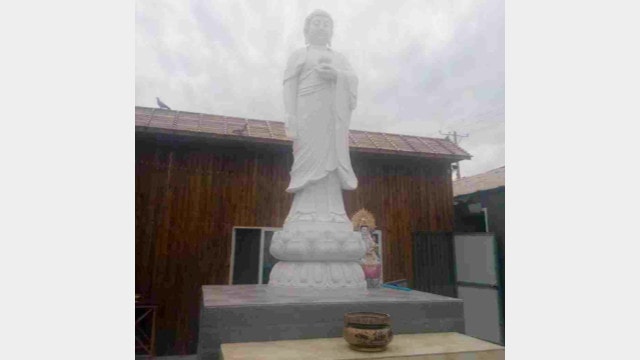 White marble Buddhist statue in a temp