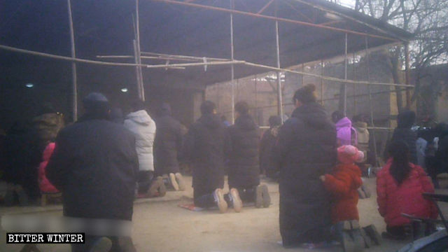 Believers kneel down on the cold ground