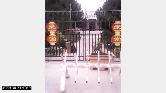 The gate in Shawan county’s Anjihai village is locked