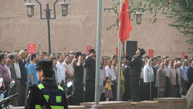 Uyghurs gather for the compulsory Monday morning political meeting