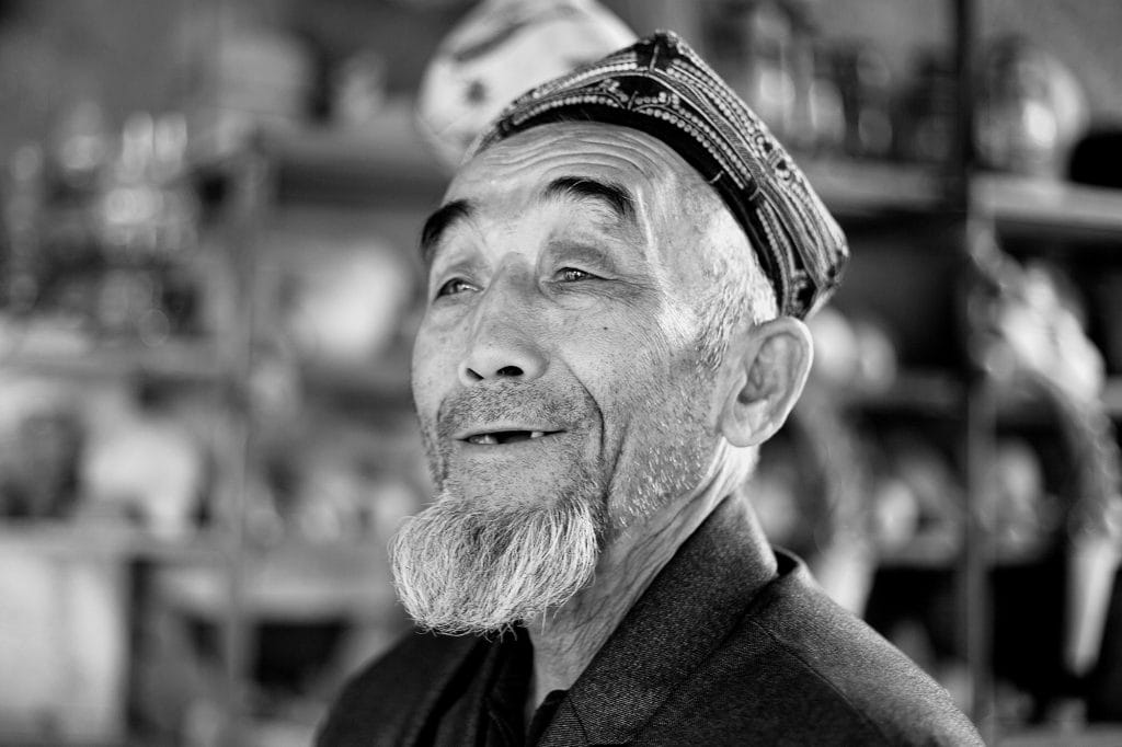 An Aksakal (an old and wise man) in his village booth near Turpan.