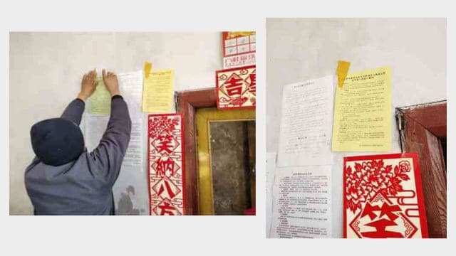 A villager pasting a flyer inciting people to boycott religion.