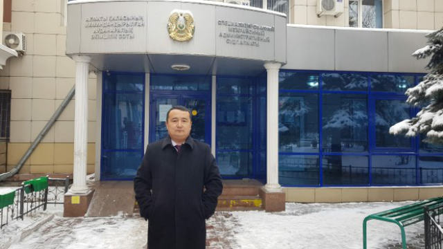 Serikzhan Bilash standing outside of the court