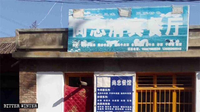 Three marks from paint appear on the signboard