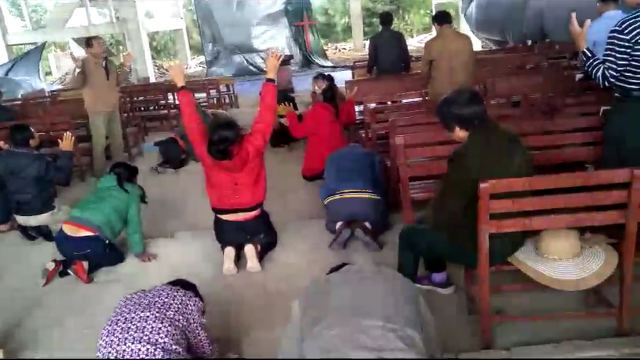 Believers are praying and crying in the church.