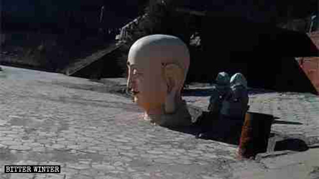 The 18-meter-tall Buddha statue was destroyed, with only the statue’s head left behind in the yard.