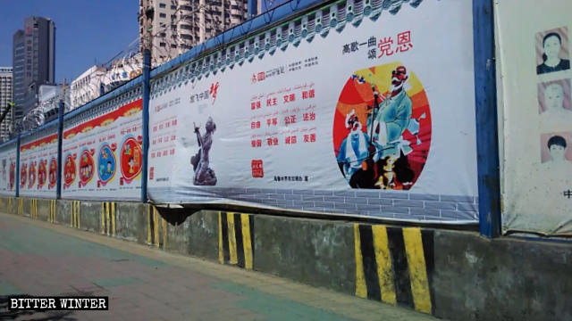 CCP propaganda posters and slogans, such as “Sing the praises to the Party loudly,” are visible everywhere on the streets.