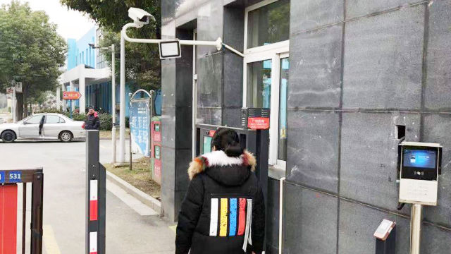 Residents must scan their face before entering a community in Zhejiang’s Yangzhou city.