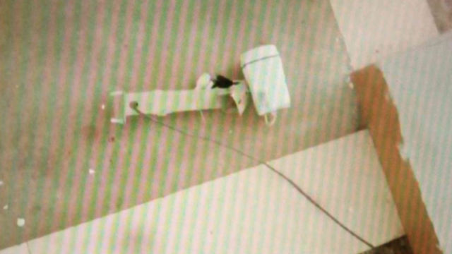 The surveillance camera on the first floor is torn down and thrown on the floor.
