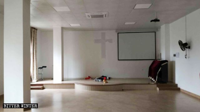 The podium, tables, and chairs have been removed from the meeting venue; and the crosses have been torn down and destroyed.