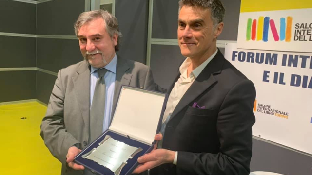 Marco Respinti receiving the award at the International Book Fair of Turin, Italy