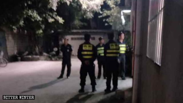 Police officers on guard at the entrance of the church