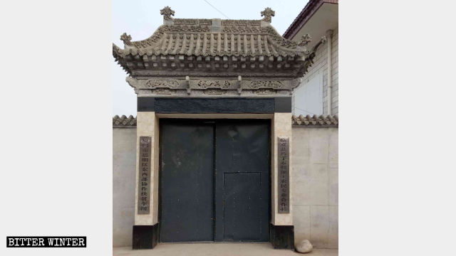 The mosque gate was replaced with an ordinary iron gate, and two new signboards inform that the building is no longer a mosque.