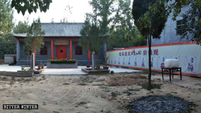 A poster of promoting the Core Socialist Values is covering the temple’s donor recognition plaque