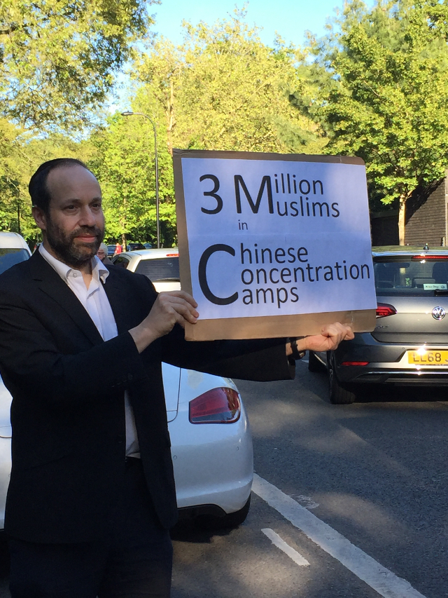 Every week, Andrew holds his placard.