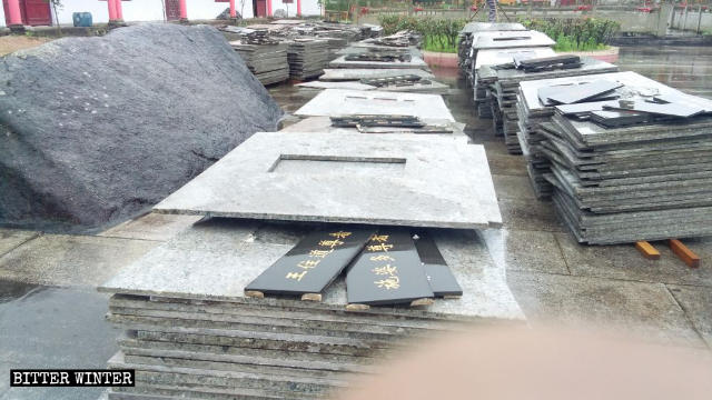 The bases of the dismantled Arhat statues sit in a pile on one side of the temple’s plaza.