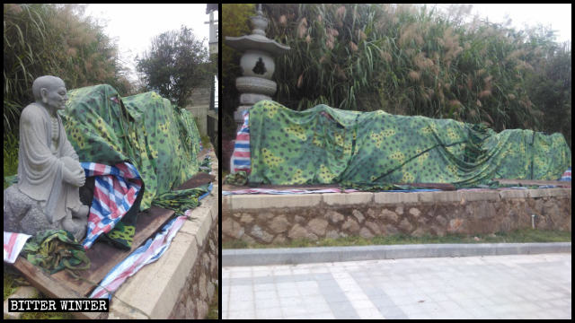 The dismantled Arhat statues are stacked in a pile to the side of the road and covered with cloth