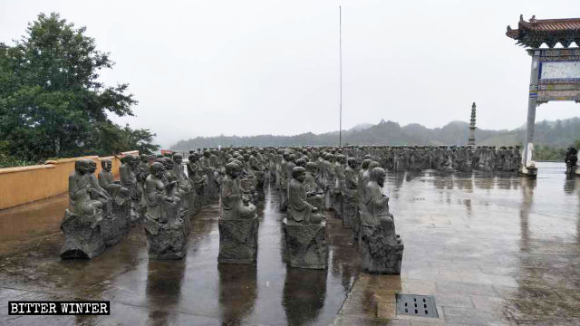 The dismantled Arhat statues are placed next to the temple’s main gate