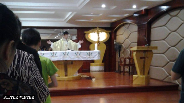 The priest was holding Mass when neighborhood committee personnel entered the church.
