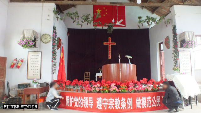 China’s national flag is hung on top of the cross inside Xinzhuang Church.