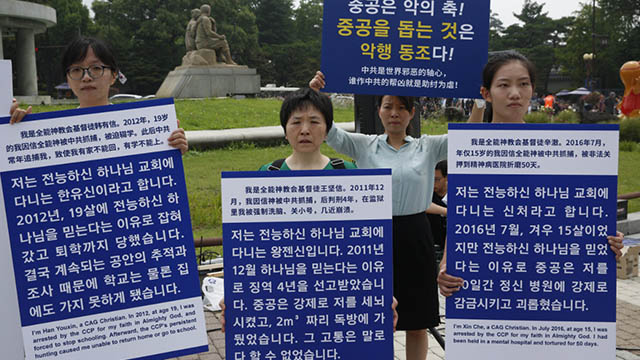 Christians hold signboards in hand