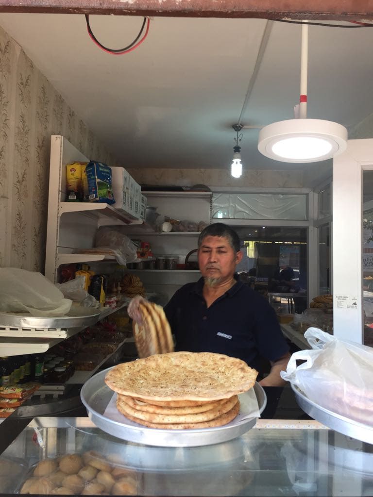 This Kashgar baker proudly displays his piping hot “naan” bread fresh